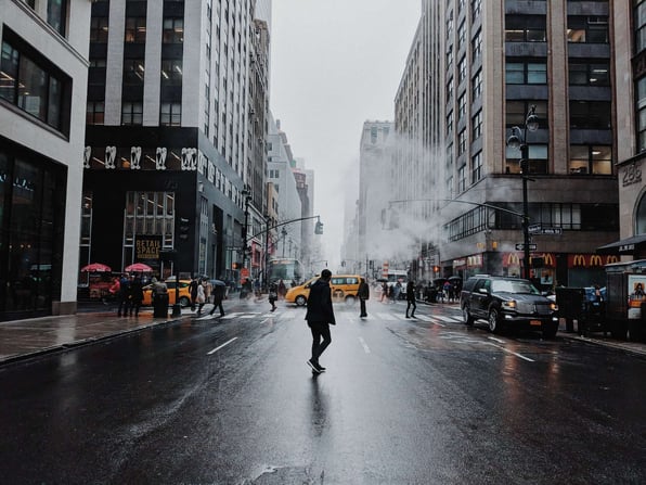 man walking in rain in nyc