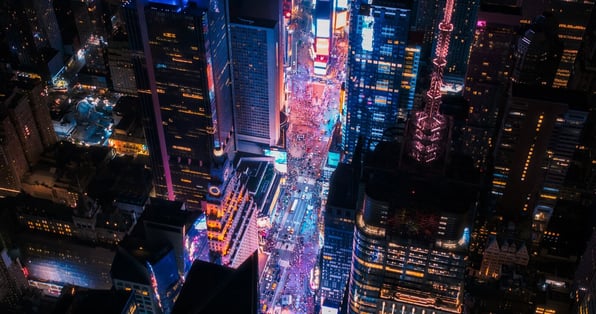 Aerial view of Times Square at night with bright neon lights.